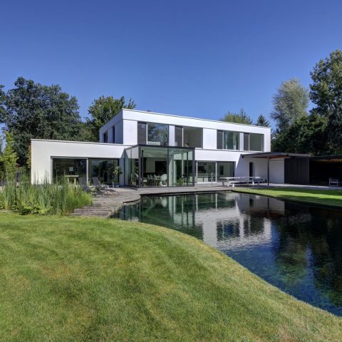 Swimming pond at modern villa in Zoersel
