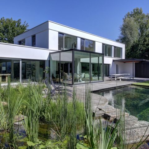 Swimming pond at modern villa in Zoersel