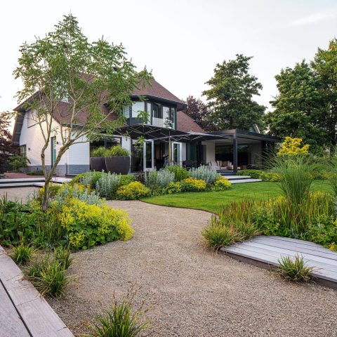 Minimalist garden with water and a wide wooden dock