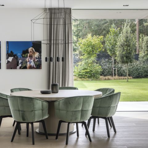 Modern architectural villa among greenery