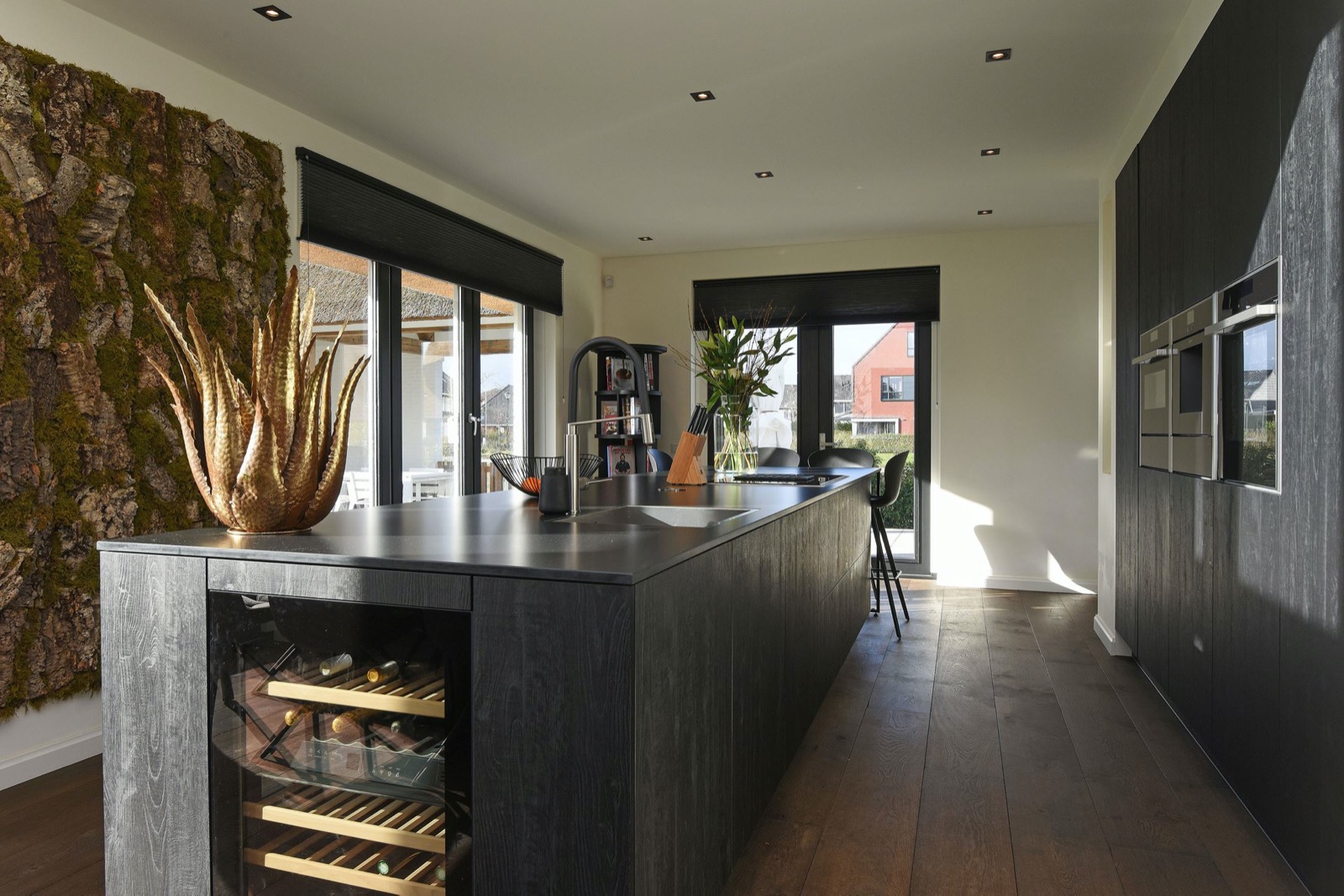Robust wooden floor, luxury black wooden kitchen with cooking island, chrome appliances ,Indoors,Room,Kitchen Island,Housing,Interior Design,Plant,Chair,Furniture,Kitchen,Flower, Luxury, Design, Exclusive, Modern, Custom Made, Special, Beautiful