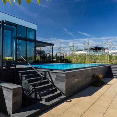 Infinity pool with overflow channel and natural stone bench seating