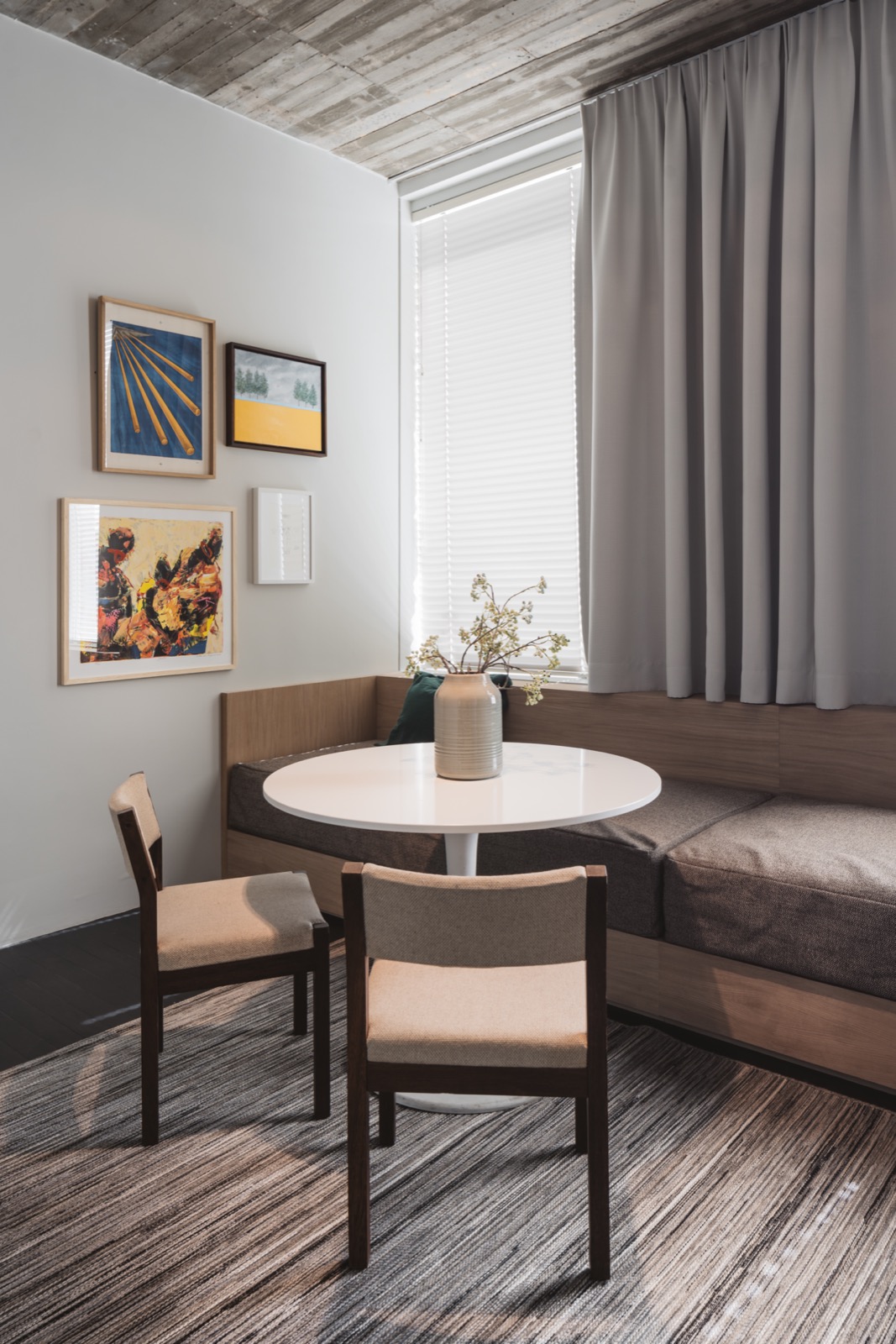 Modern wooden sofa with grey cushions, high gloss white round dining table, wooden dining chairs with beige upholstery ,Chair,Furniture,Table,Indoors,Room,Dining Table,Interior Design,Housing,Bedroom,Dining Room, Luxury, Design, Exclusive, Modern, Custom Made, Special, Beautiful