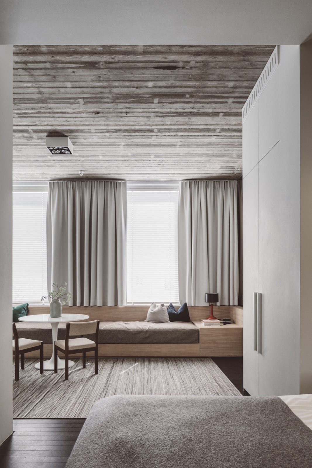 Modern wooden sofa with grey cushions, high gloss white round dining table, wooden dining chairs with beige upholstery ,Chair,Furniture,Housing,Indoors,Rug,Interior Design,Home Decor,Curtain,Room,Corridor, Luxury, Design, Exclusive, Modern, Custom Made, Special, Beautiful