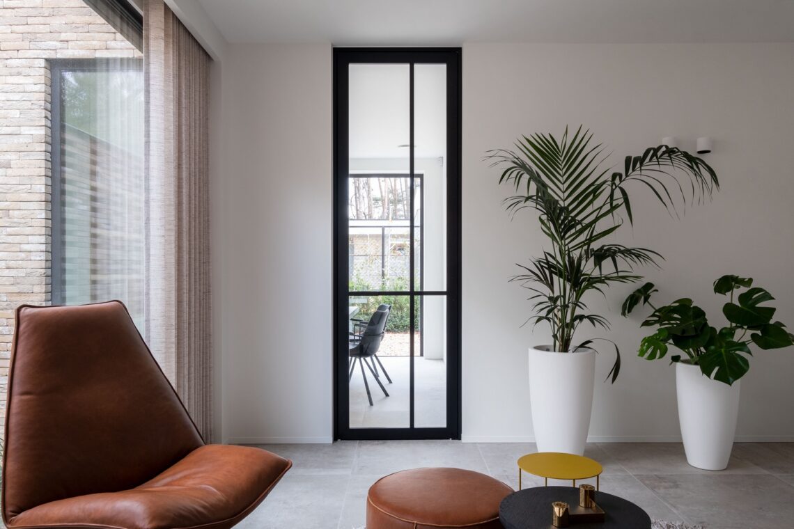 a living room filled with furniture and a large window