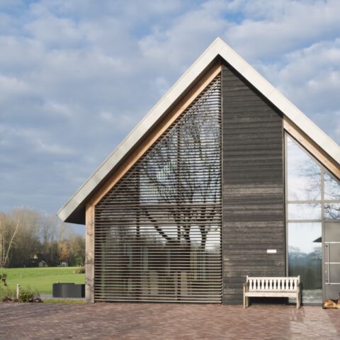 Barn house fitted with slatted western red cedar blinds