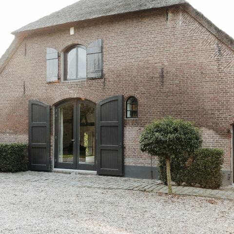 Residential farmhouse with authentic insulated steel barn windows