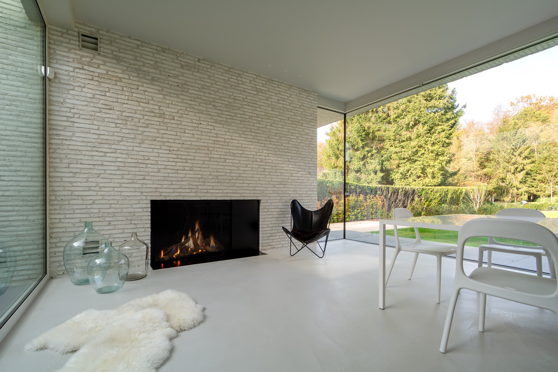 Prachtig beige stenen wand, luxe gashaard met glas, betonvloer ,Open haard, Binnen, Open haard, Interieurontwerp, Woondecoratie, Meubels, Tafel, Stoel, Eettafel, Woonkamer, Luxe, Design, Exclusief, Modern, Maatwerk, Bijzondere, Mooie