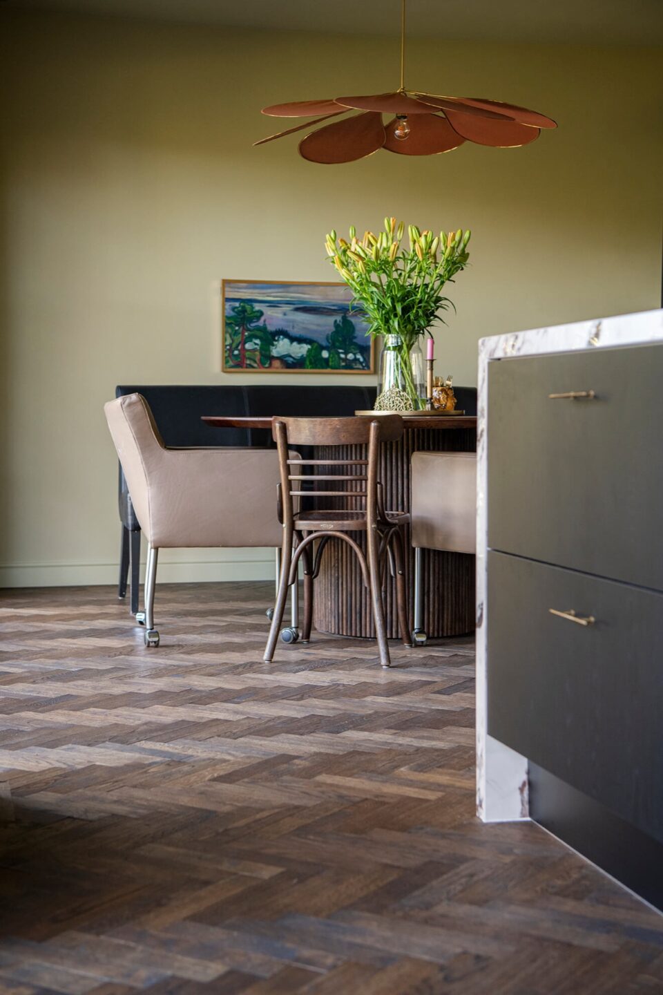 Dark herringbone floor with black kitchen with marble countertops
