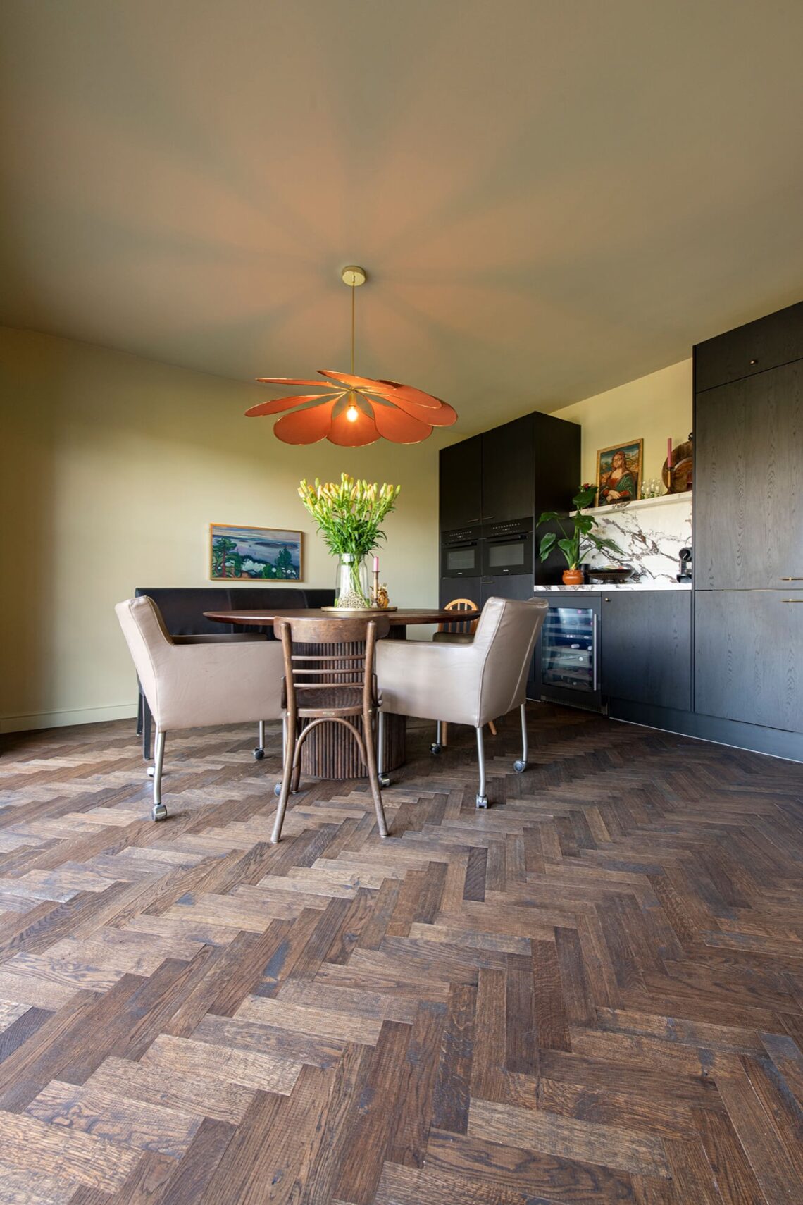 Dark herringbone floor with black kitchen with marble countertops