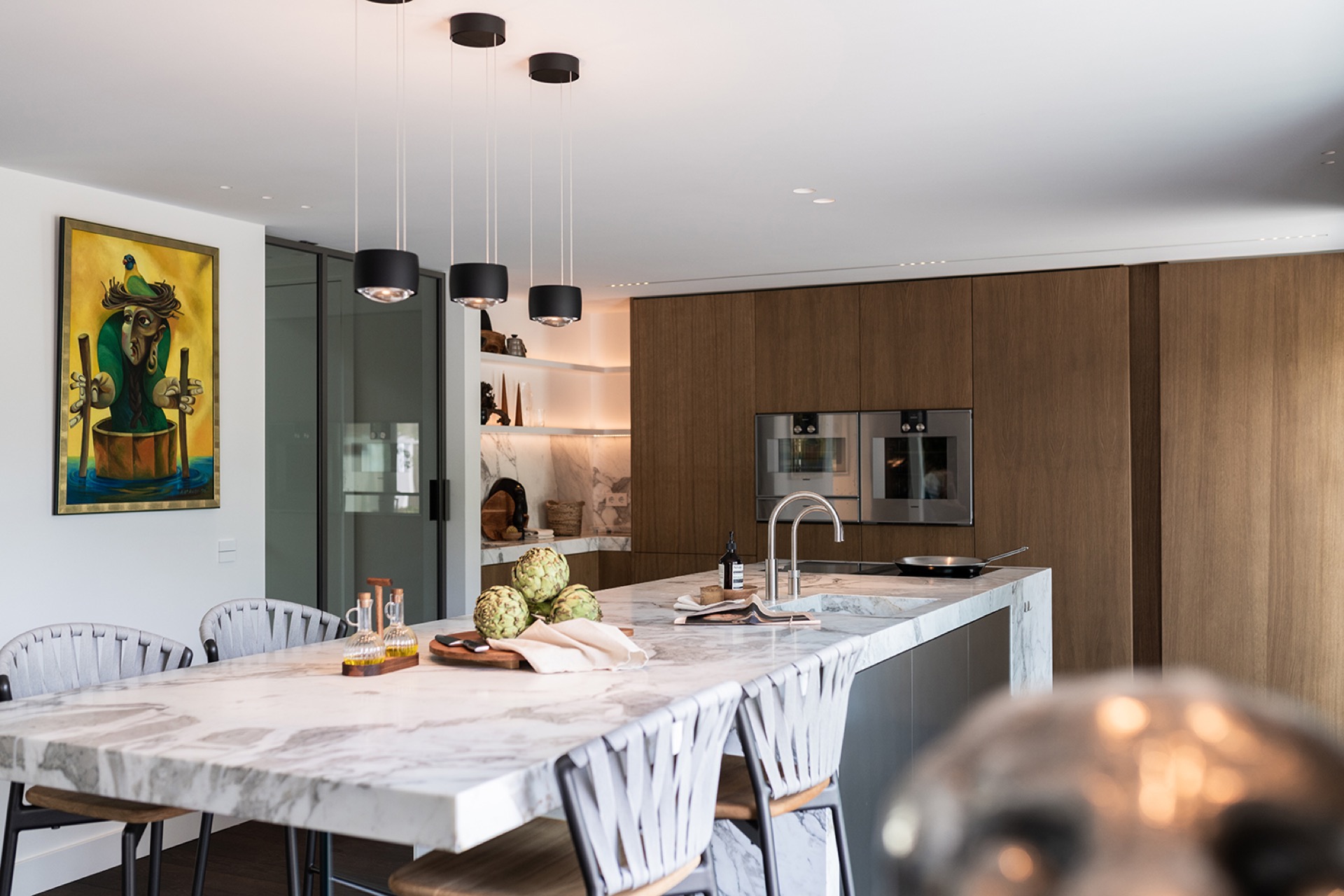 luxury full home interior: luxury kitchen with marble countertop, pendant lights, and a wood wall with built-in appliances, Luxury, Design, Exclusive, Modern, Custom Made, Special, Beautiful