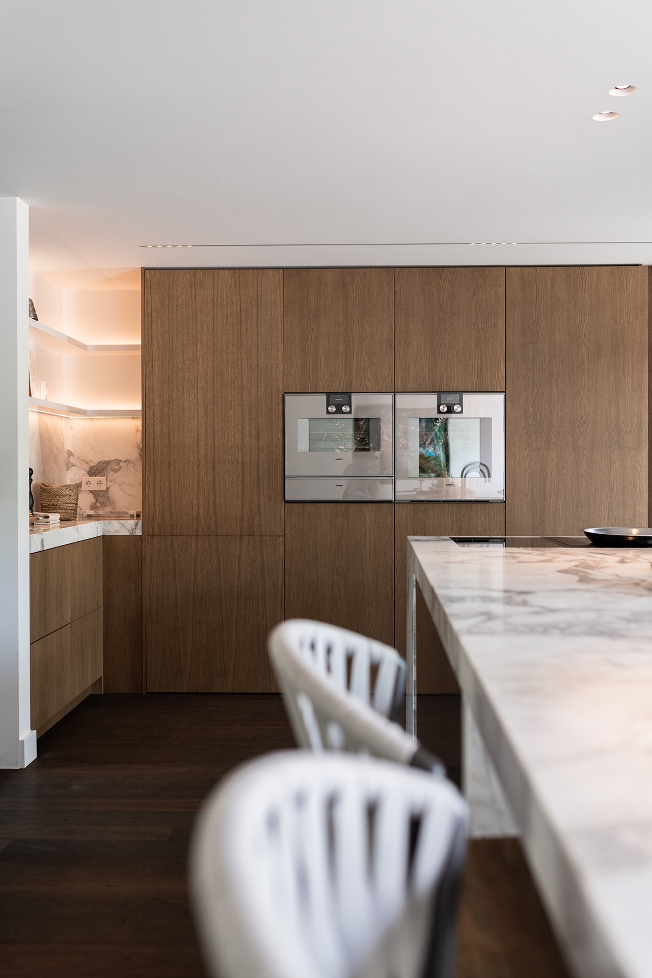 luxury full home interior: kitchen wall with tall wood fronts and built-in glass sections, finished with clean lines, Luxury, Design, Exclusive, Modern, Custom Made, Special, Beautiful