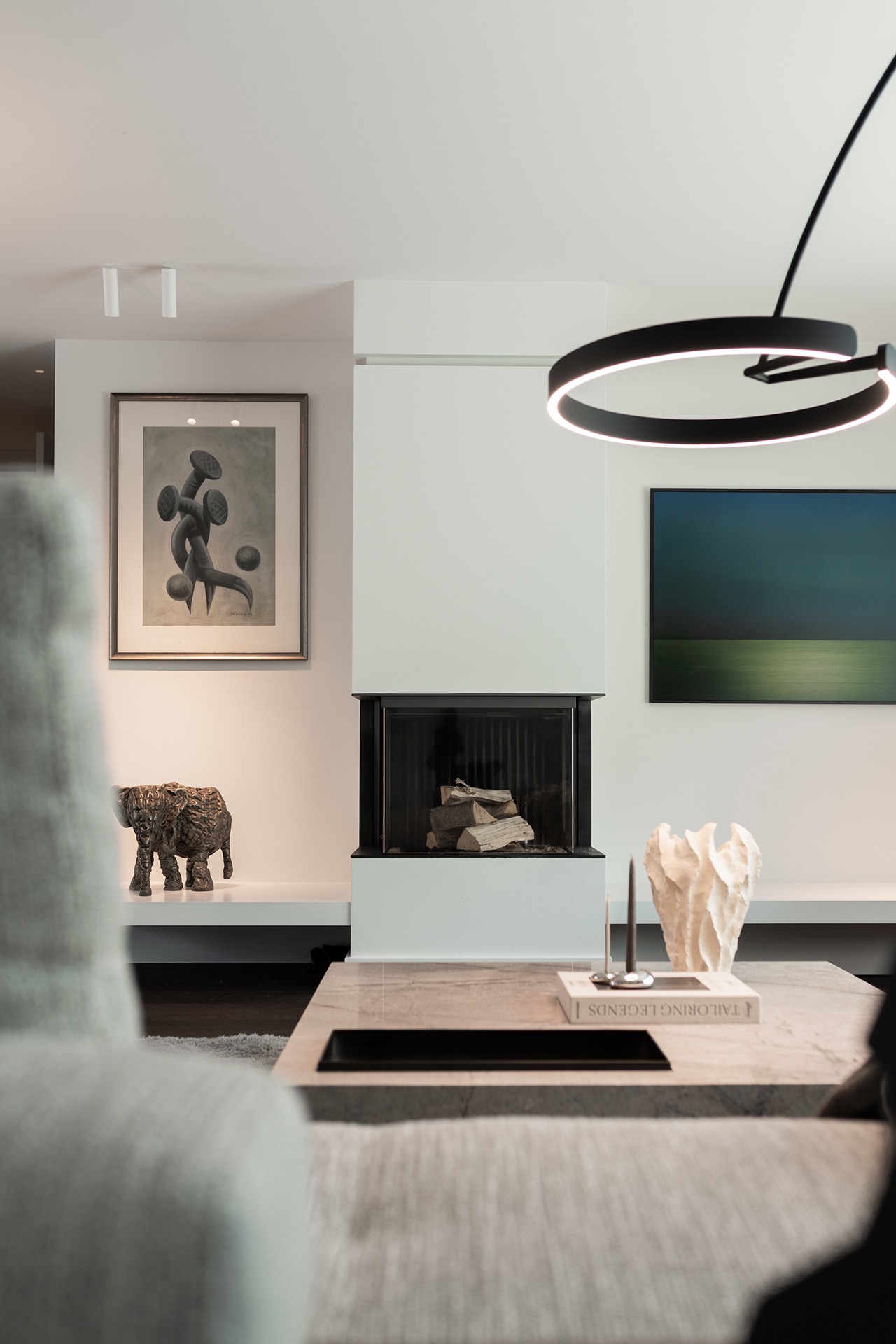 luxury full home interior: detail of an open fireplace with a circular ring light and a black glass insert, Luxury, Design, Exclusive, Modern, Custom Made, Special, Beautiful