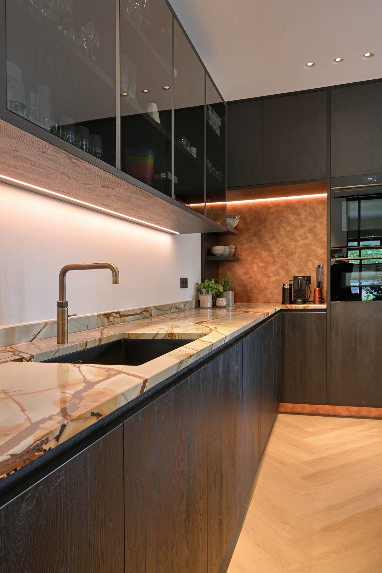 indirect LED lighting in a luxury villa interior: kitchen detail with glass upper cabinet, marble-look countertop and LED, Luxury, Design, Exclusive, Modern, Custom Made, Special, Beautiful