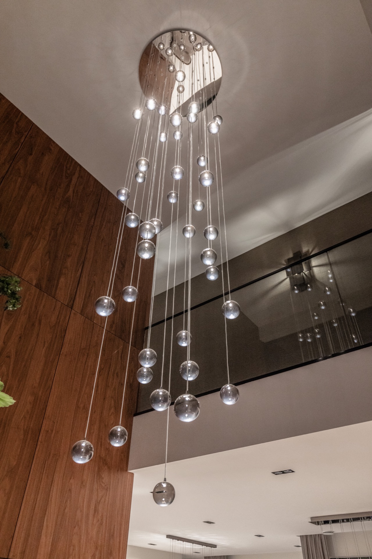 luxury pendant lighting interior: detail of spherical pendant lights with long cords and warm wooden wall panels, Luxury, Design, Exclusive, Modern, Custom Made, Special, Beautiful