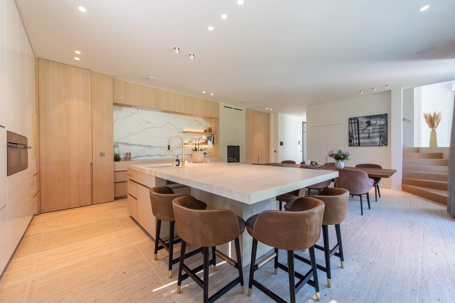 modern villa interior: open-plan kitchen with island, stone-look countertop and built-in wood cabinetry, Luxury, Design, Exclusive, Modern, Custom Made, Special, Beautiful