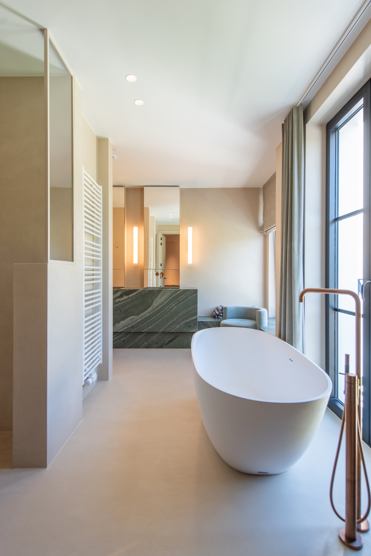modern villa interior: bathroom with freestanding bathtub, natural window light and niche wall with stone-look panel, Luxury, Design, Exclusive, Modern, Custom Made, Special, Beautiful