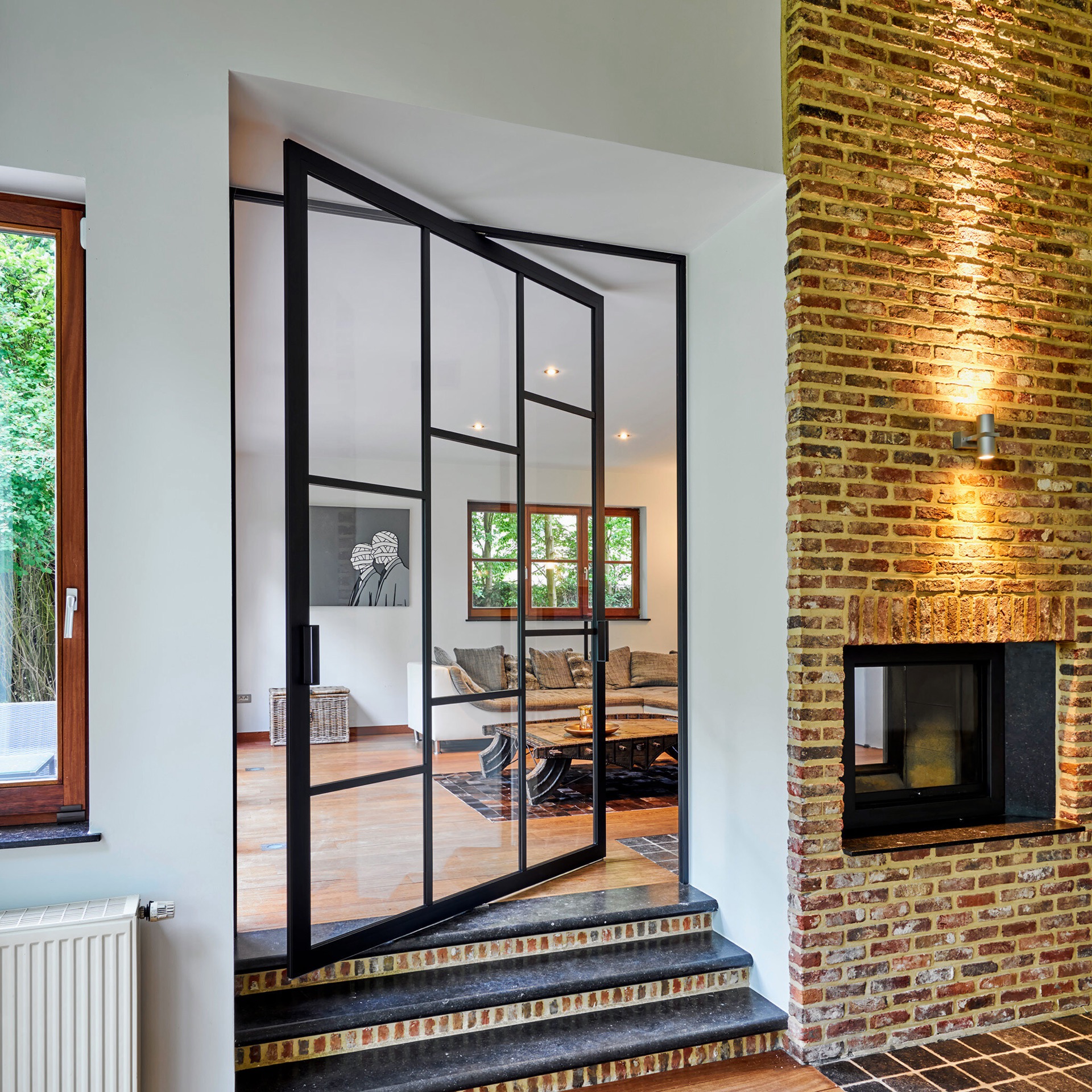 Steel look pivotdeur met zwart kozijn en glazen panelen bij bakstenen gevel, Luxury, Design, Exclusive, Modern, Custom Made, Special, Beautiful