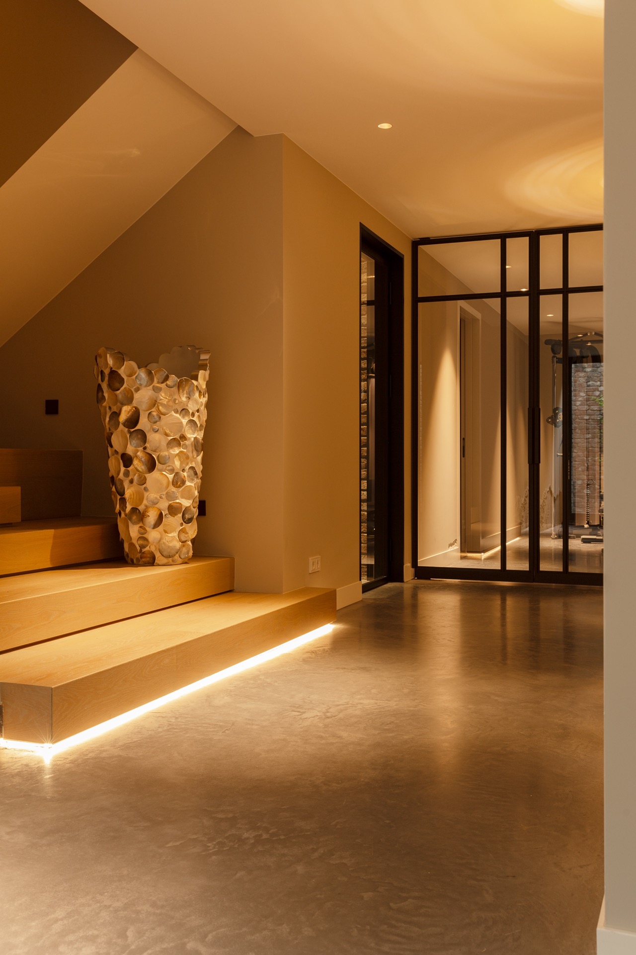 floated concrete floor in new-build villa: floated concrete floor with warm lighting and glass door in the entrance, Luxury, Design, Exclusive, Modern, Custom Made, Special, Beautiful