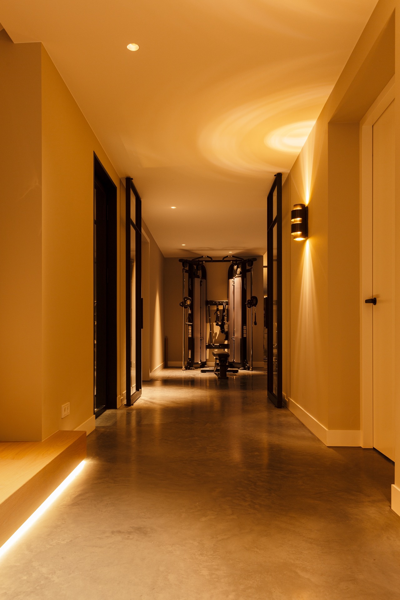 floated concrete floor in new-build villa: long hallway with continuous floated concrete floor and warm ceiling lights, Luxury, Design, Exclusive, Modern, Custom Made, Special, Beautiful