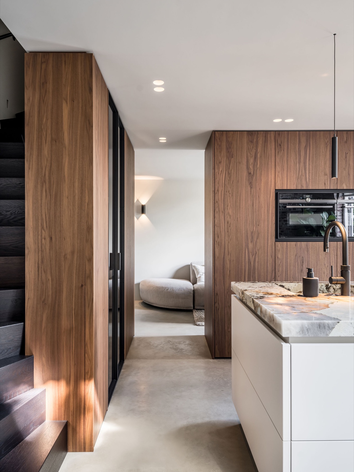 custom walnut kitchen with natural stone countertop: kitchen and living area with custom walnut wood walls and natural stone, Luxe, Design, Exclusief, Modern, Maatwerk, Bijzondere, Mooie