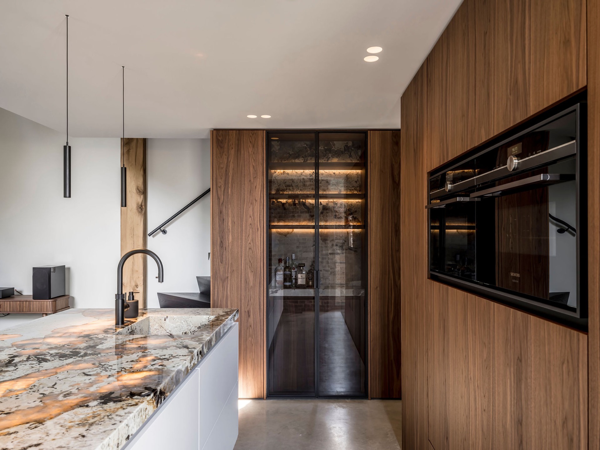 custom walnut kitchen with natural stone countertop: natural stone kitchen countertop with walnut cabinets and pendant lights, Luxe, Design, Exclusief, Modern, Maatwerk, Bijzondere, Mooie