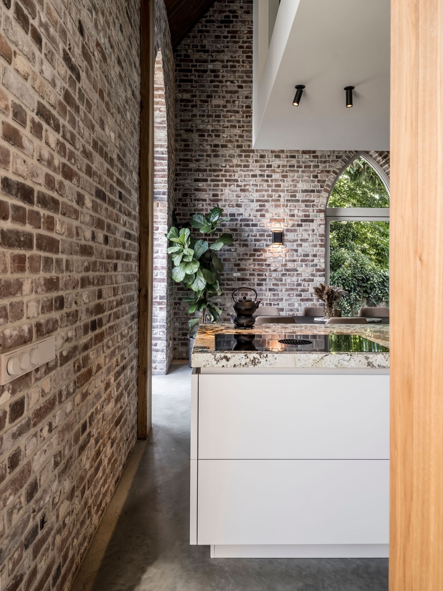 custom walnut kitchen with natural stone countertop: kitchen interior with brick arch opening and walnut custom fronts, Luxe, Design, Exclusief, Modern, Maatwerk, Bijzondere, Mooie