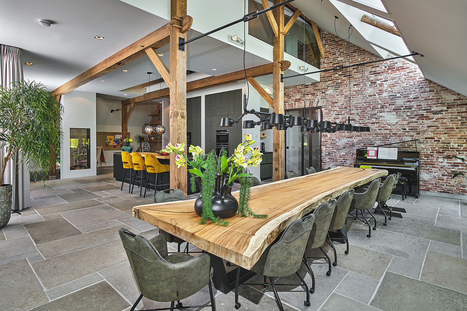 open kitchen with cooking island: kitchen interior with cooking island, pendant lights and a brick wall section on the right, Luxe, Design, Exclusief, Modern, Maatwerk, Bijzondere, Mooie