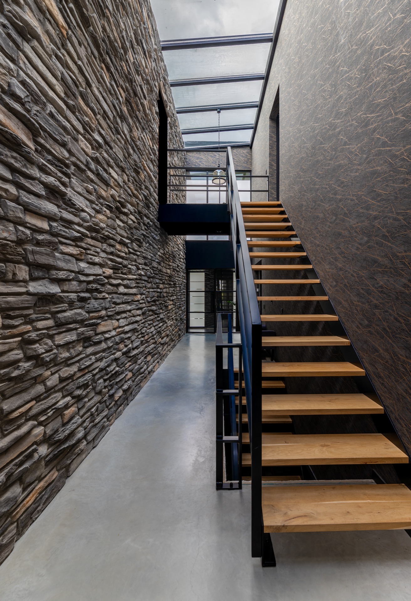 modern home natural stone strip cladding: gallery edge with black railing and natural stone wall with glass openings under, Luxe, Design, Exclusief, Modern, Maatwerk, Bijzondere, Mooie