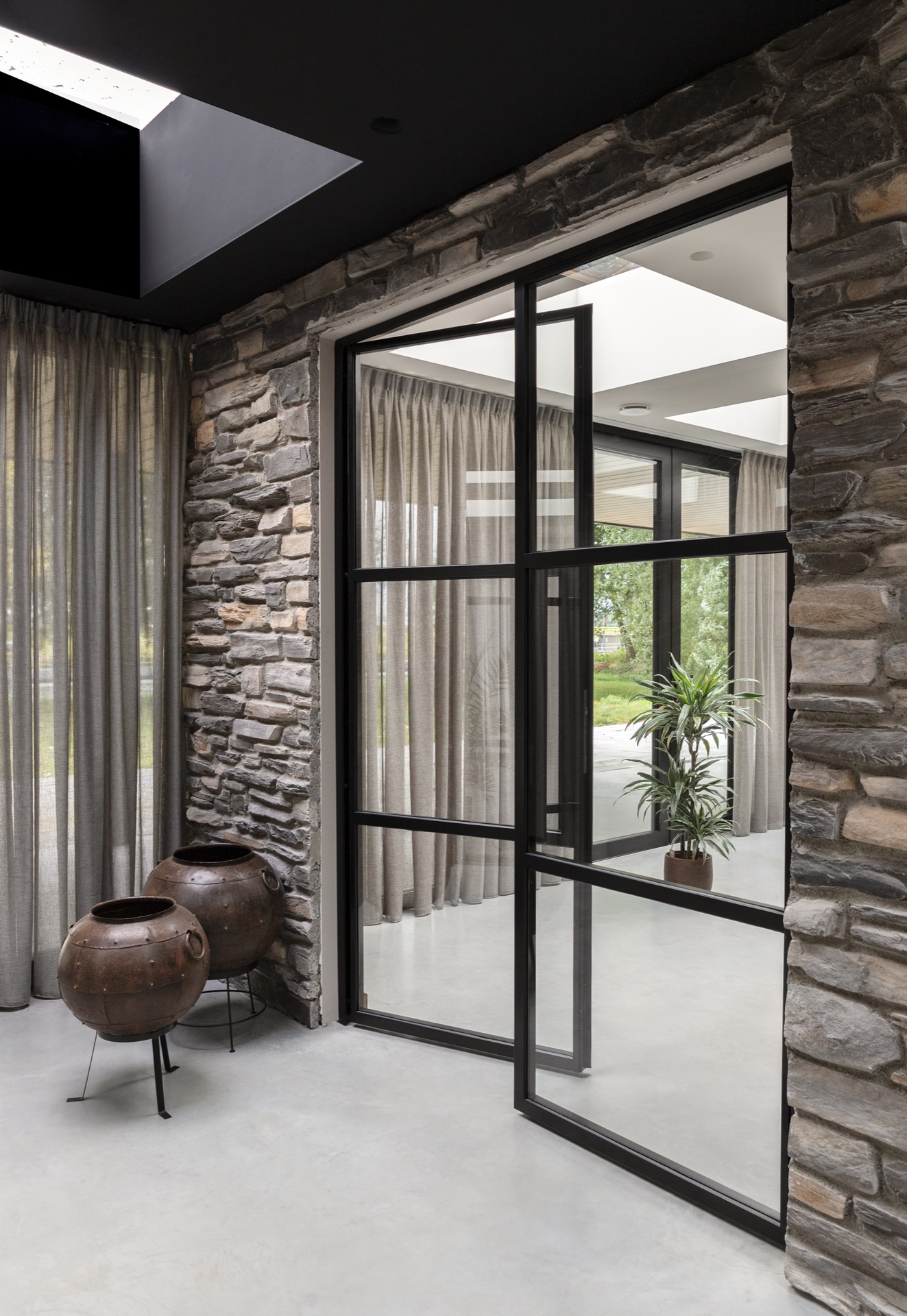 modern home natural stone strip cladding: stair area with black railing, natural stone wall and large glass sections in a, Luxe, Design, Exclusief, Modern, Maatwerk, Bijzondere, Mooie