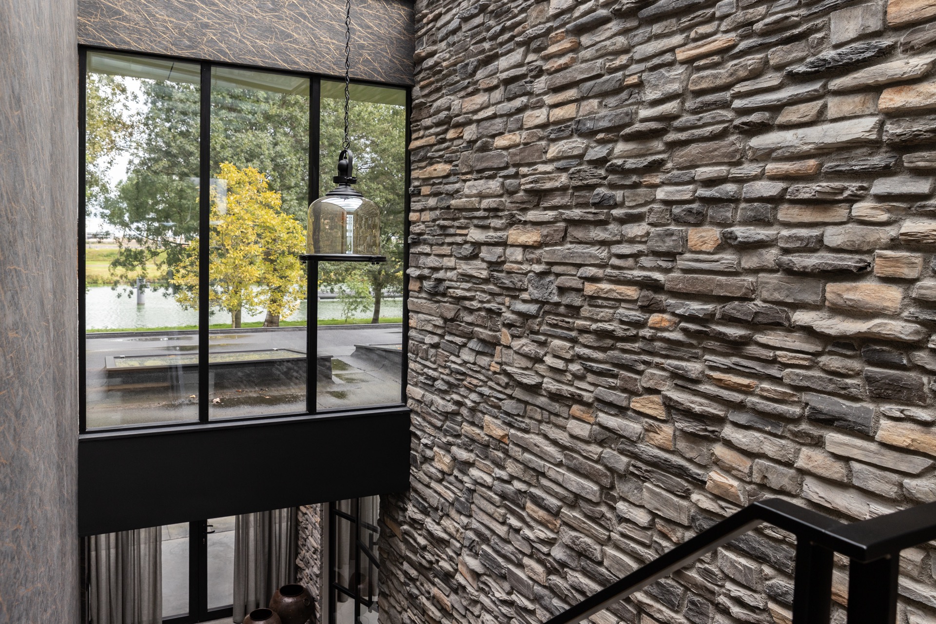 modern home natural stone strip cladding: close-up of natural stone wall with hanging lamp and window opening with black, Luxe, Design, Exclusief, Modern, Maatwerk, Bijzondere, Mooie