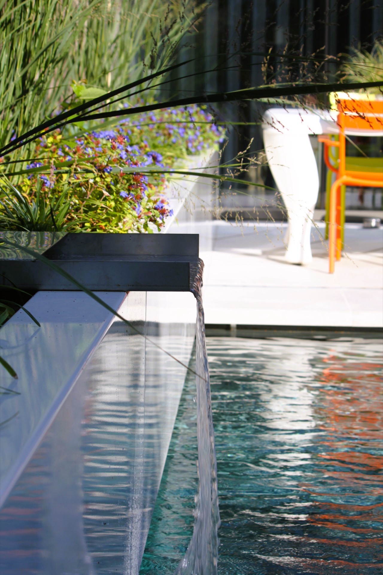 pool lounge area: close-up of pool water with a view toward the terrace and modern pool edge, Luxury, Design, Exclusive, Modern, Custom Made, Special, Beautiful