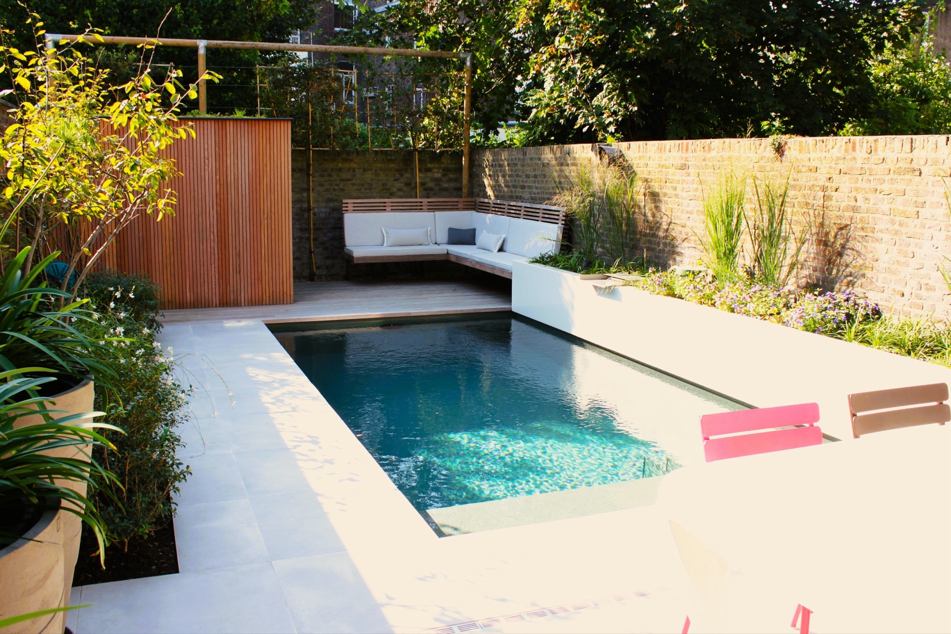 pool lounge area: view of the pool in a patio garden with ceramic paving, white edges and lounge seating, Luxury, Design, Exclusive, Modern, Custom Made, Special, Beautiful