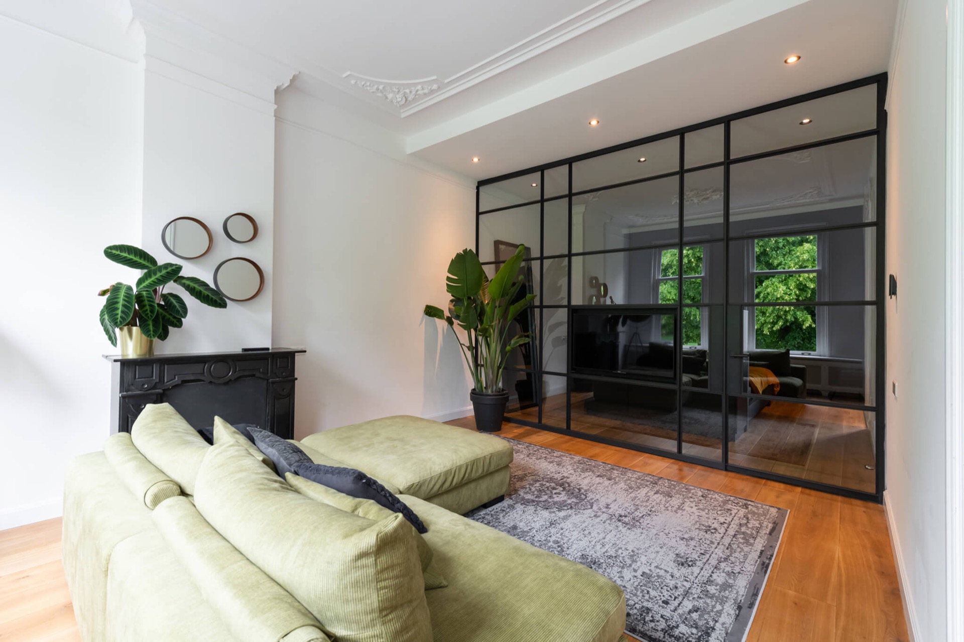 glass TV wall with hinged door: glass and aluminum cinewall with black framing and a TV niche in the living room, Luxury, Design, Exclusive, Modern, Custom Made, Special, Beautiful