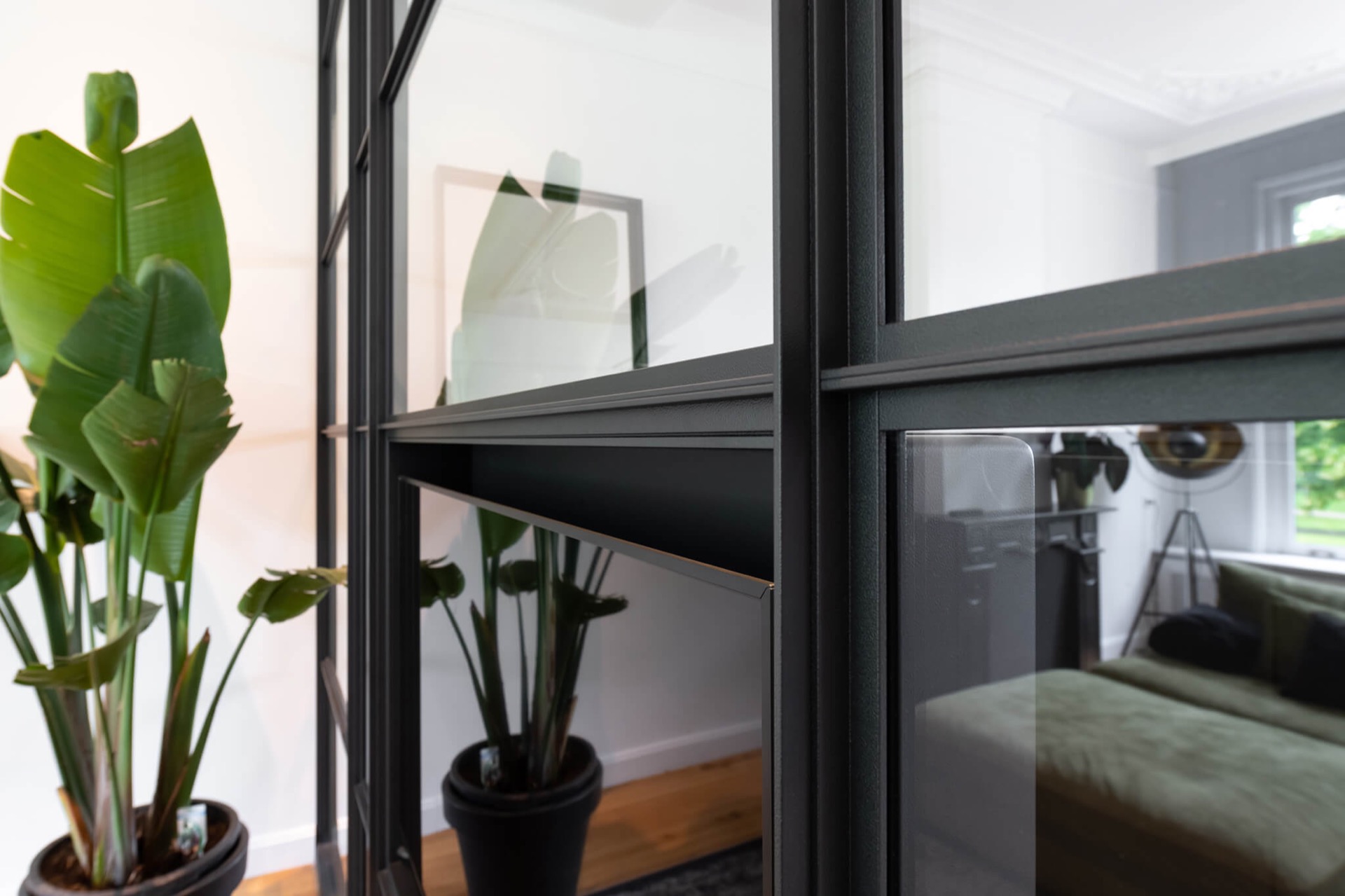 glass TV wall with hinged door: side view of a glass cinewall with a black aluminum frame and open doorway, Luxury, Design, Exclusive, Modern, Custom Made, Special, Beautiful