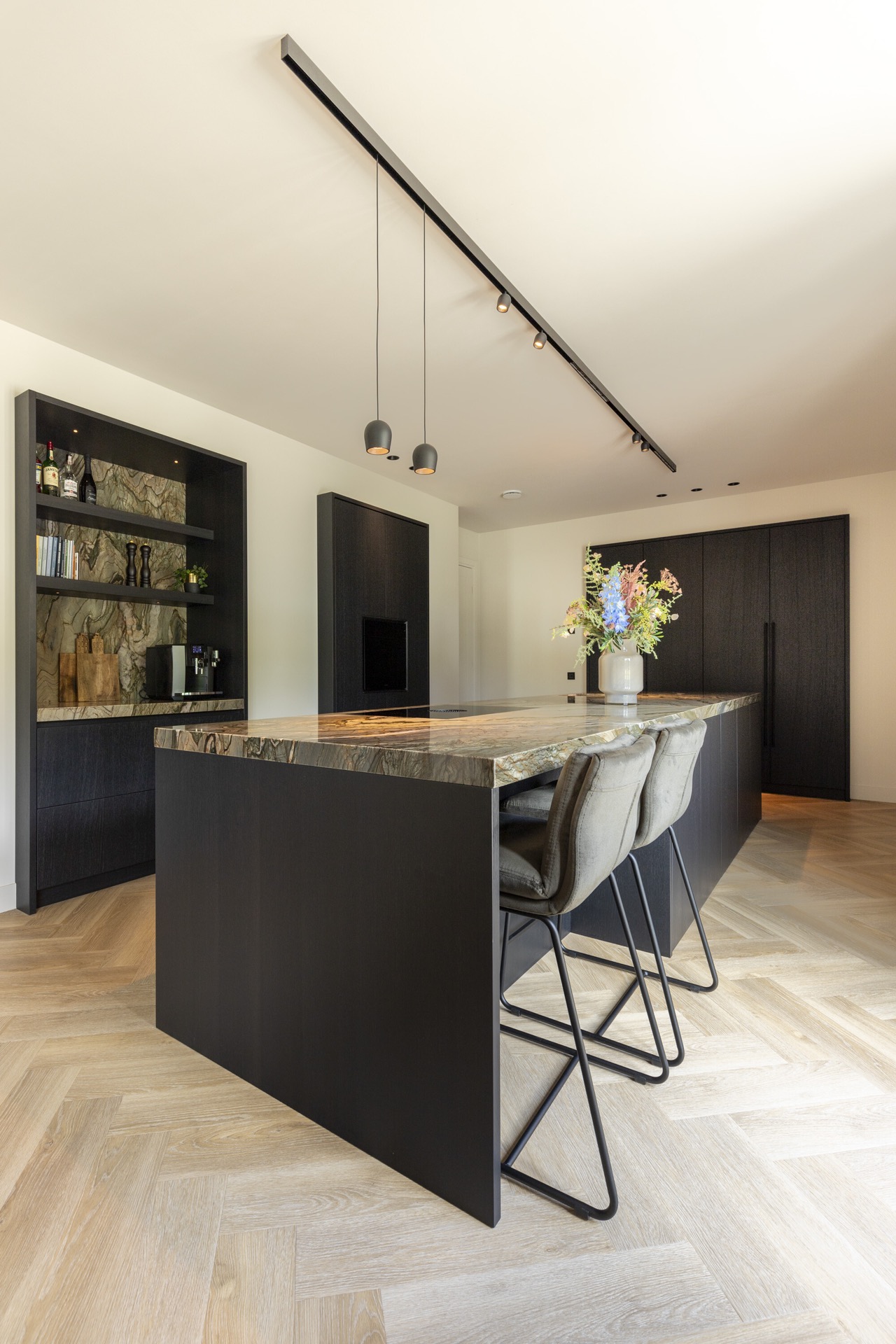 Isola cucina con piano in pietra naturale vista laterale e parete di armadi scuri con nicchia, Luxury, Design, Exclusive, Modern, Custom Made, Special, Beautiful