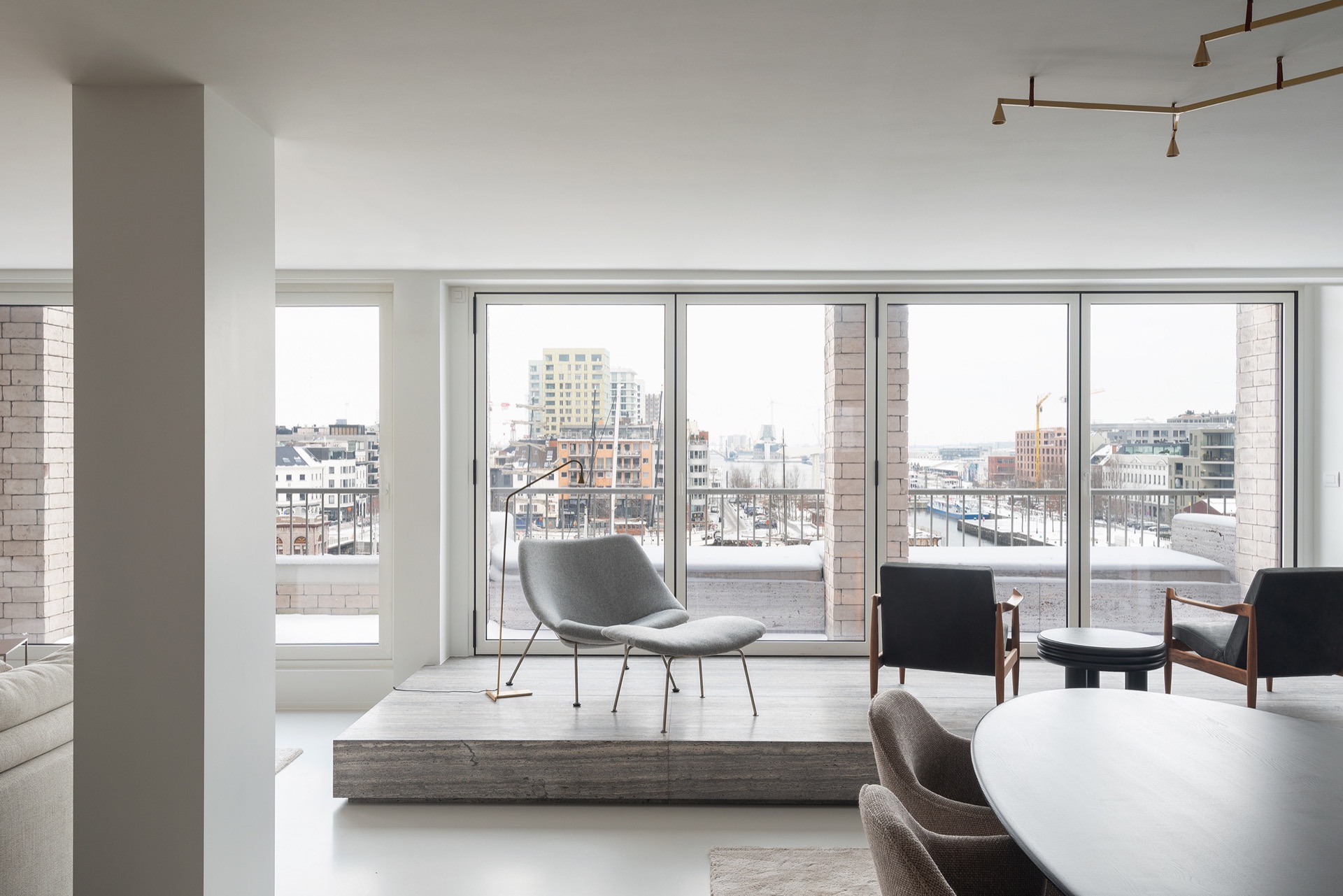 penthouse interior renovation: penthouse living with large windows, natural stone framing and gray polished flooring, Luxe, Design, Exclusief, Modern, Maatwerk, Bijzondere, Mooie