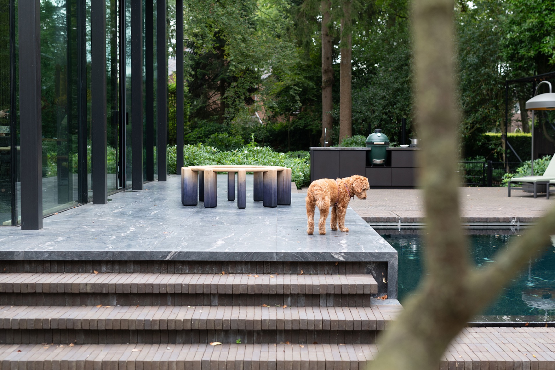 modern outdoor kitchen with natural stone worktop: outdoor kitchen on a terrace with a water feature and glass facade in a, Luxury, Design, Exclusive, Modern, Custom Made, Special, Beautiful