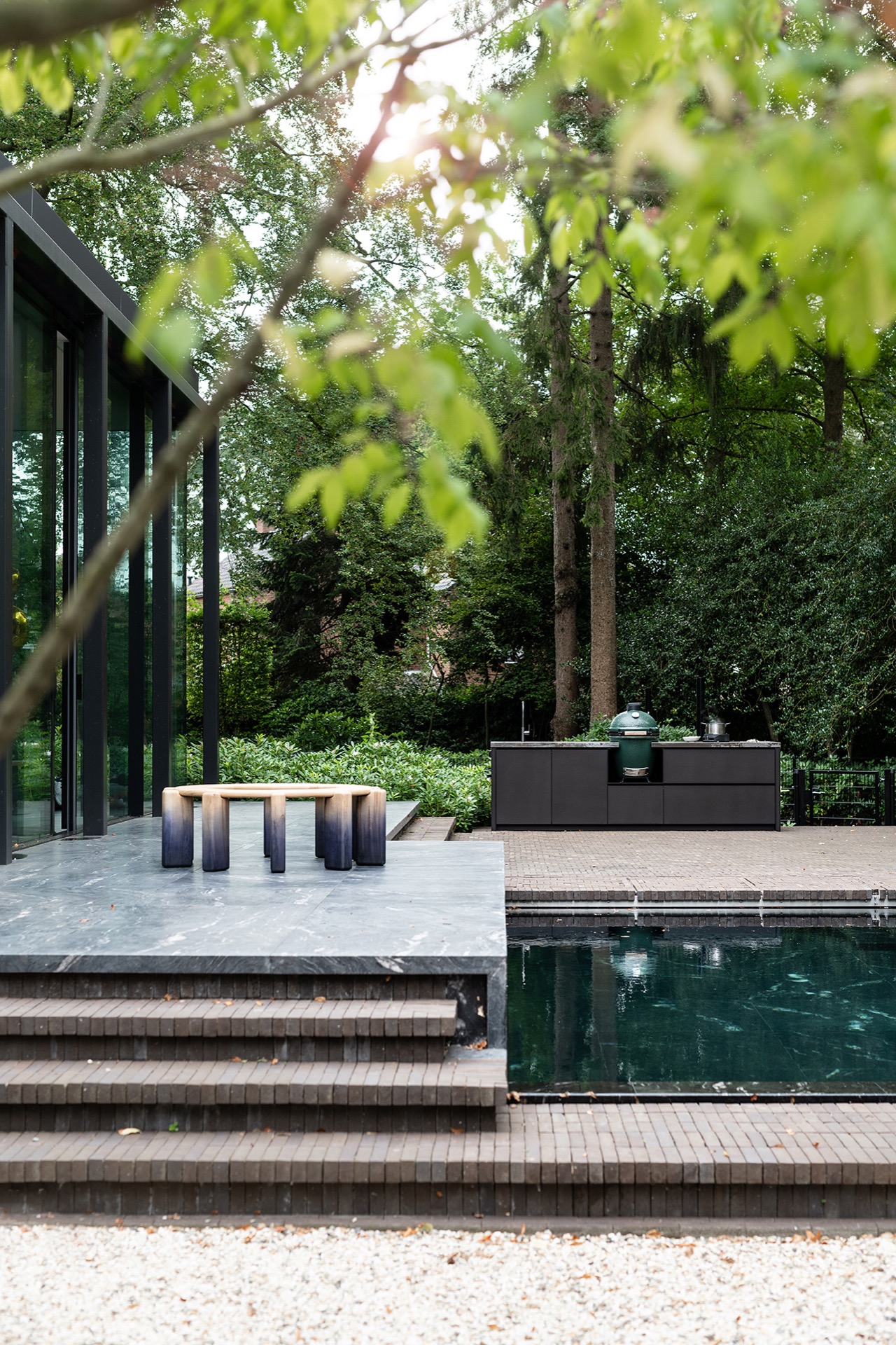 modern outdoor kitchen with natural stone worktop: modern outdoor kitchen with dark front on a natural-stone terrace beside, Luxury, Design, Exclusive, Modern, Custom Made, Special, Beautiful