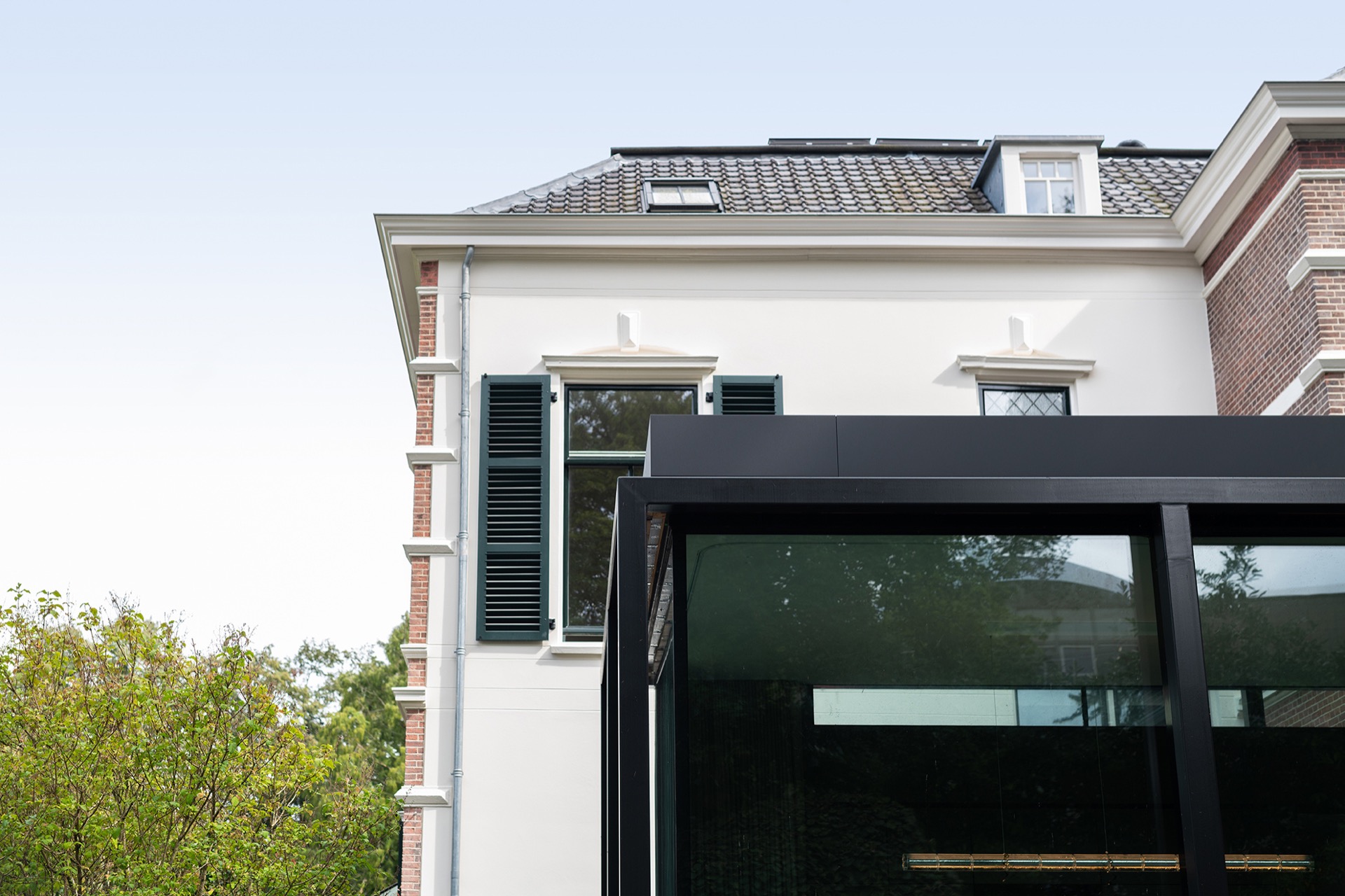 modern outdoor kitchen with natural stone worktop: facade view with a glass extension and a dark outdoor kitchen structure, Luxury, Design, Exclusive, Modern, Custom Made, Special, Beautiful