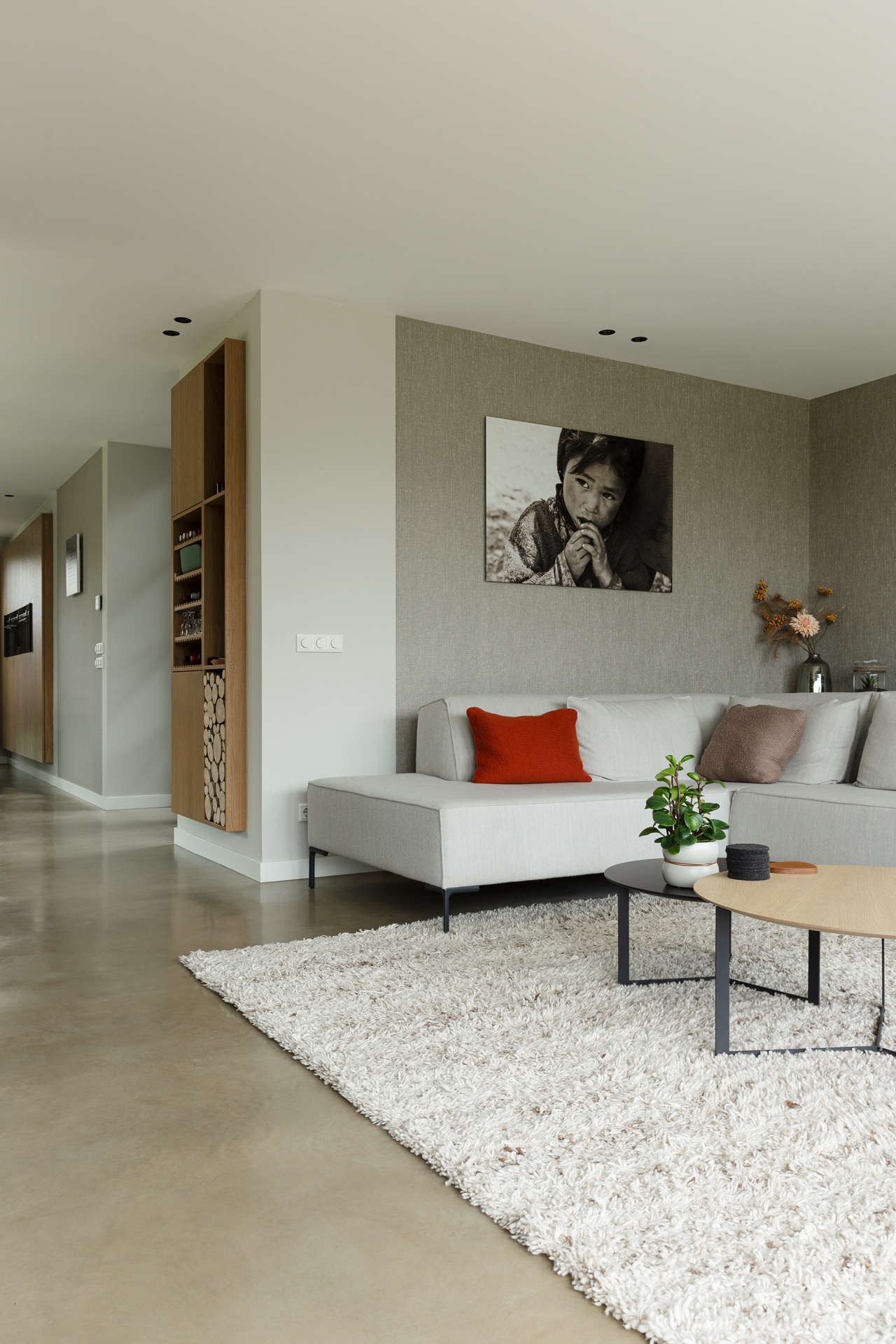 concrete floor in detached house: living area with sofa and light grey textured wall in a modern home, Luxury, Design, Exclusive, Modern, Custom Made, Special, Beautiful