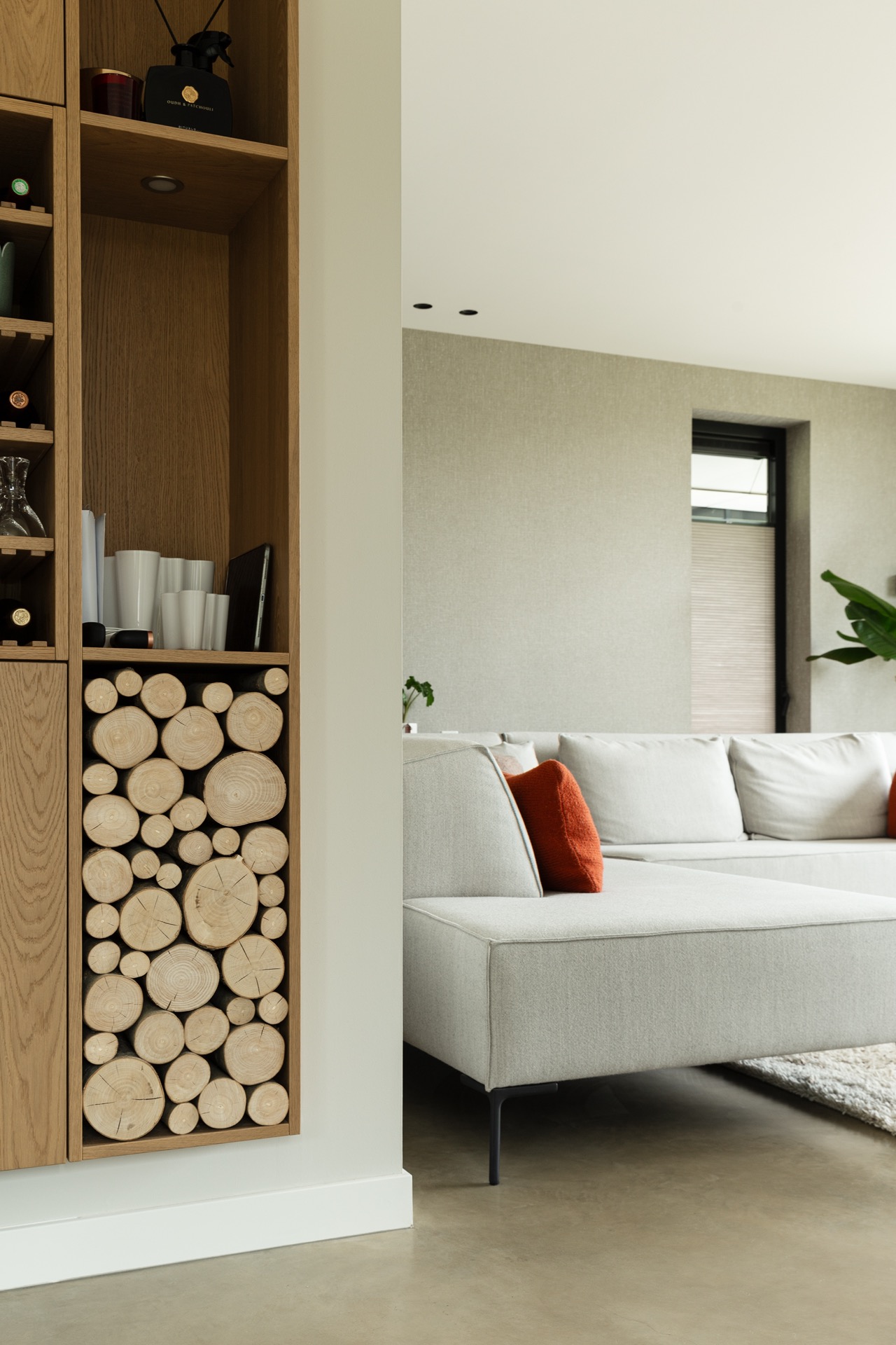 concrete floor in detached house: wooden niche with open compartments and a sofa corner in a modern living room, Luxury, Design, Exclusive, Modern, Custom Made, Special, Beautiful