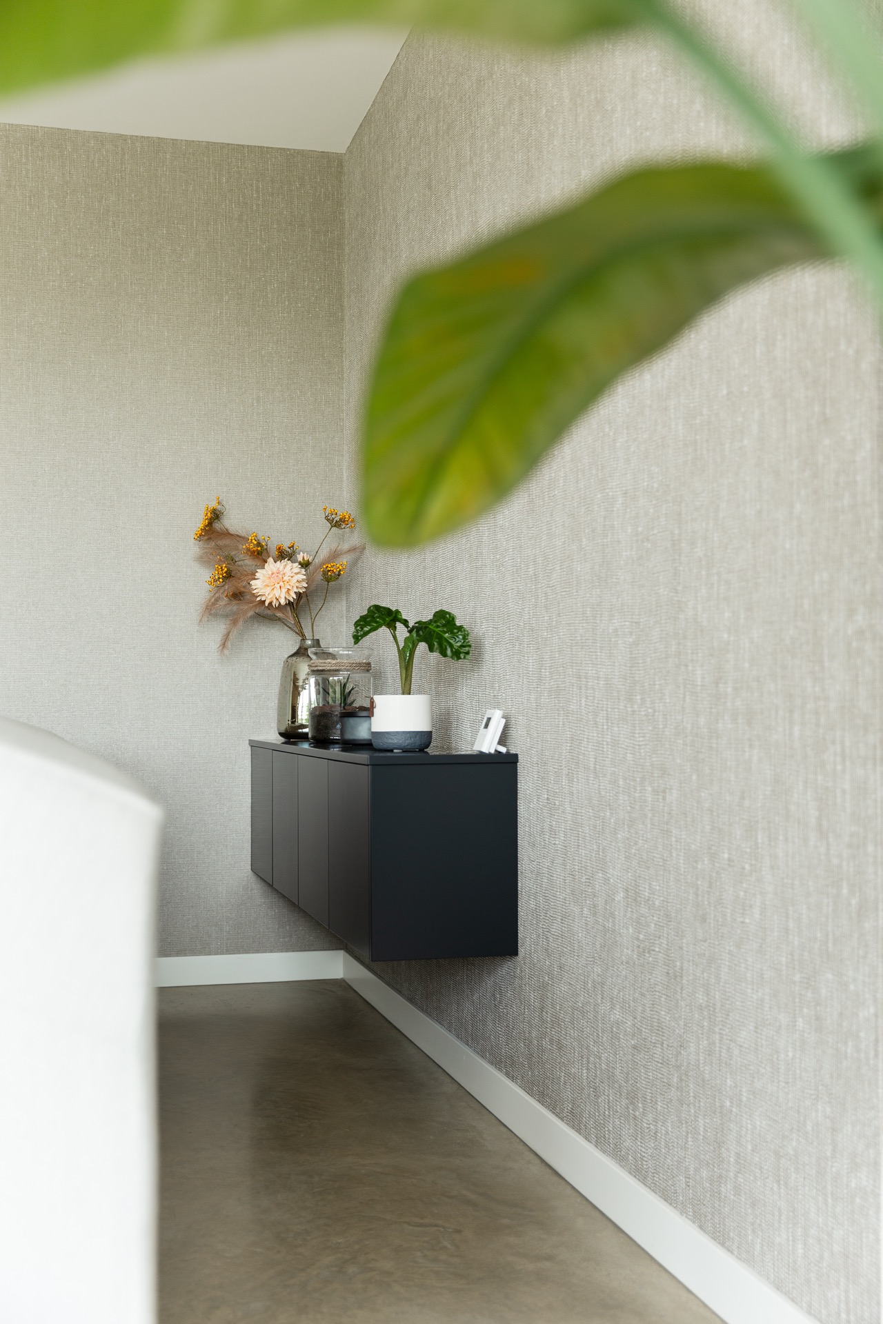 concrete floor in detached house: textured wall with low cabinet and corner arrangement in a modern living room, Luxury, Design, Exclusive, Modern, Custom Made, Special, Beautiful