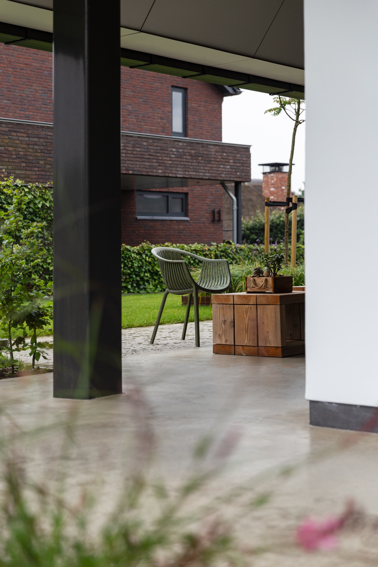 concrete floor in detached house: terrace canopy with view toward a brick facade and concrete terrace floor, Luxury, Design, Exclusive, Modern, Custom Made, Special, Beautiful