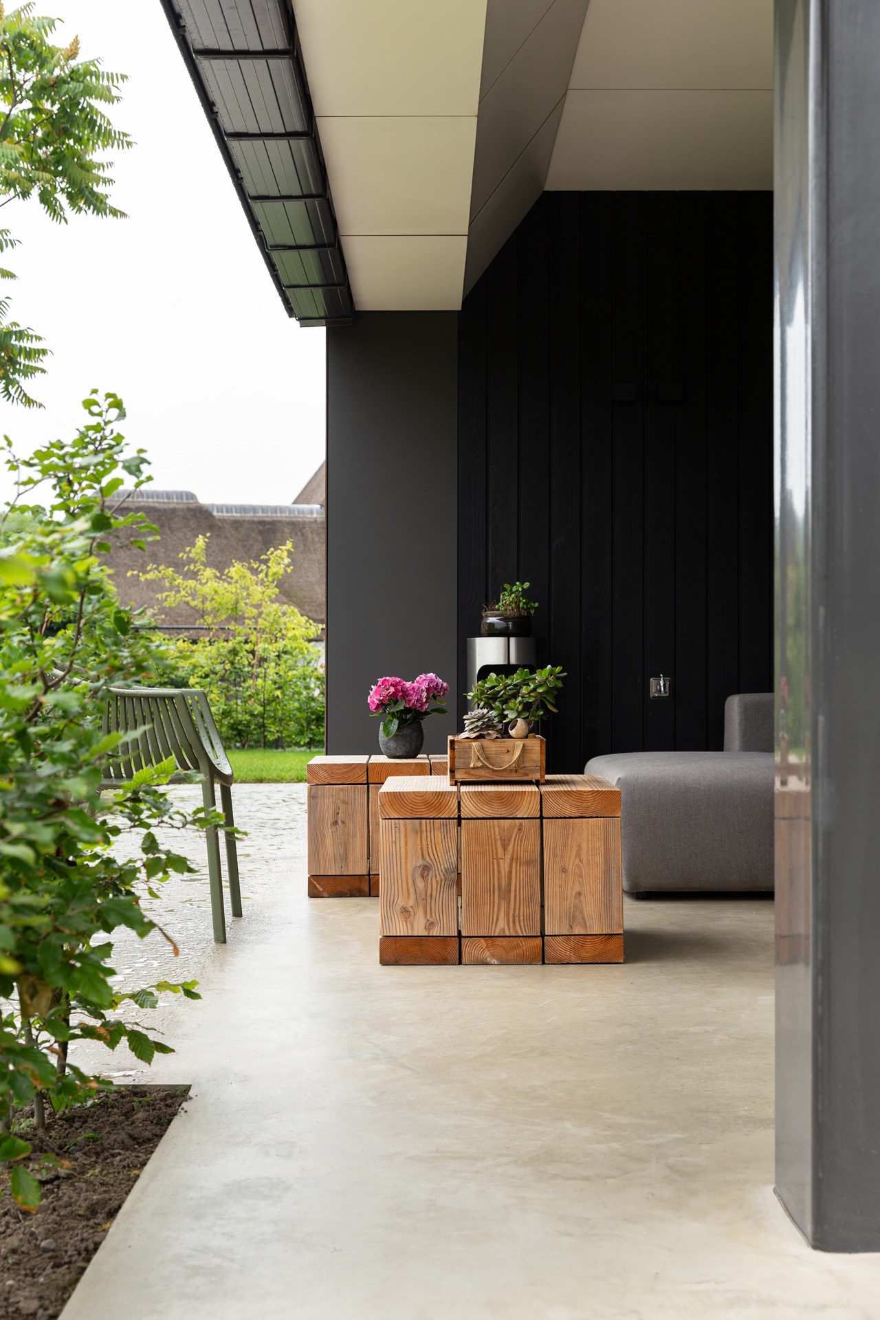 concrete floor in detached house: covered terrace with concrete floor, dark wood facade, and glass panel, Luxury, Design, Exclusive, Modern, Custom Made, Special, Beautiful