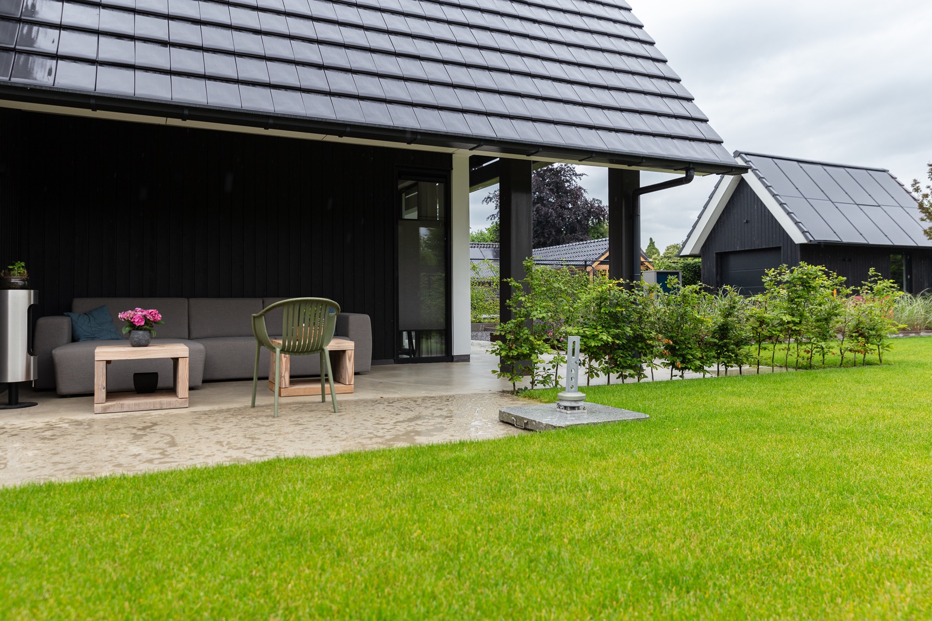 concrete floor in detached house: modern terrace with concrete floor, lawn, and dark wood facade with glass door, Luxury, Design, Exclusive, Modern, Custom Made, Special, Beautiful
