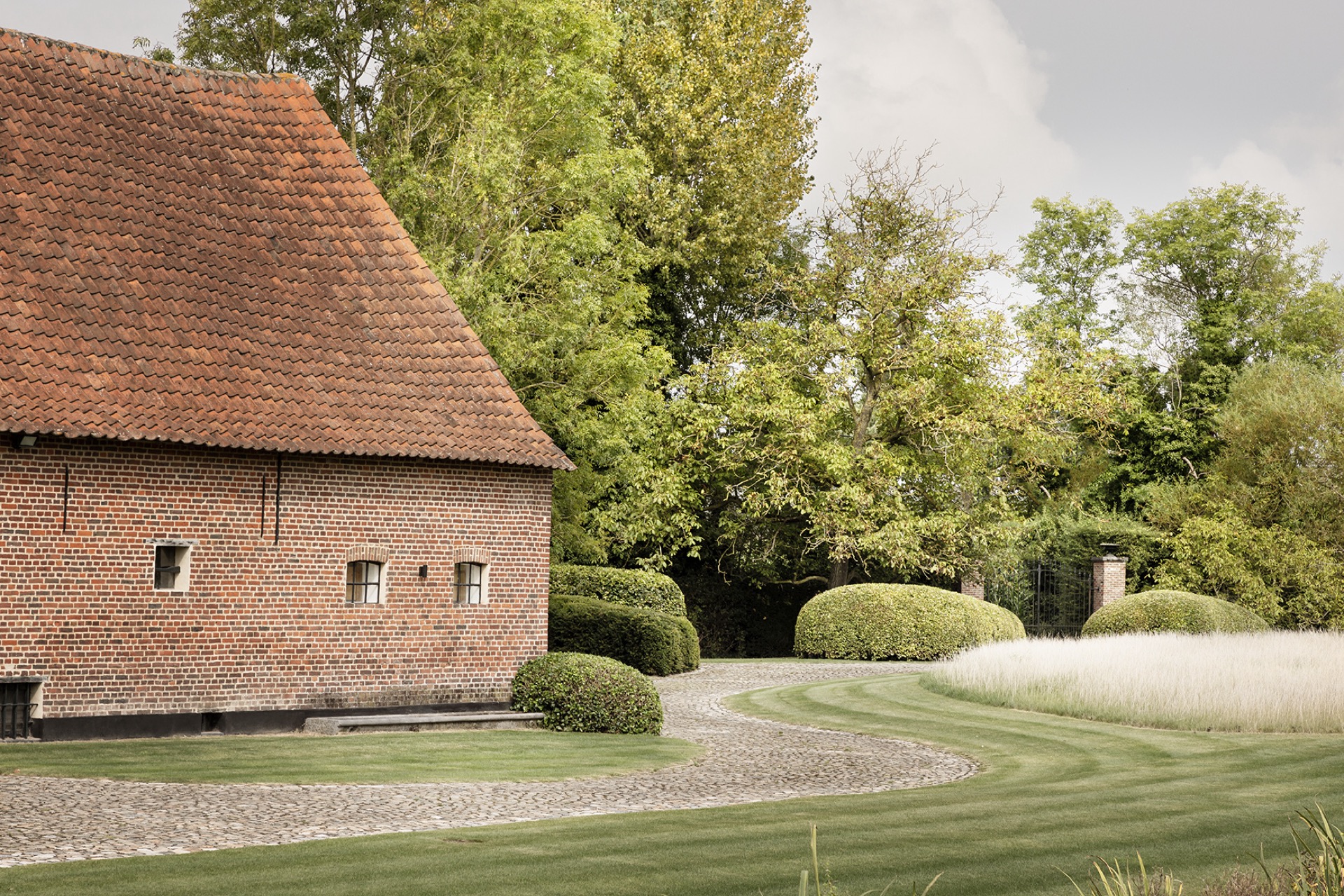 landscape garden sightline: garden overview with undulating lawn, paths and an outbuilding with red roof tiles, Luxury, Design, Exclusive, Modern, Custom Made, Special, Beautiful