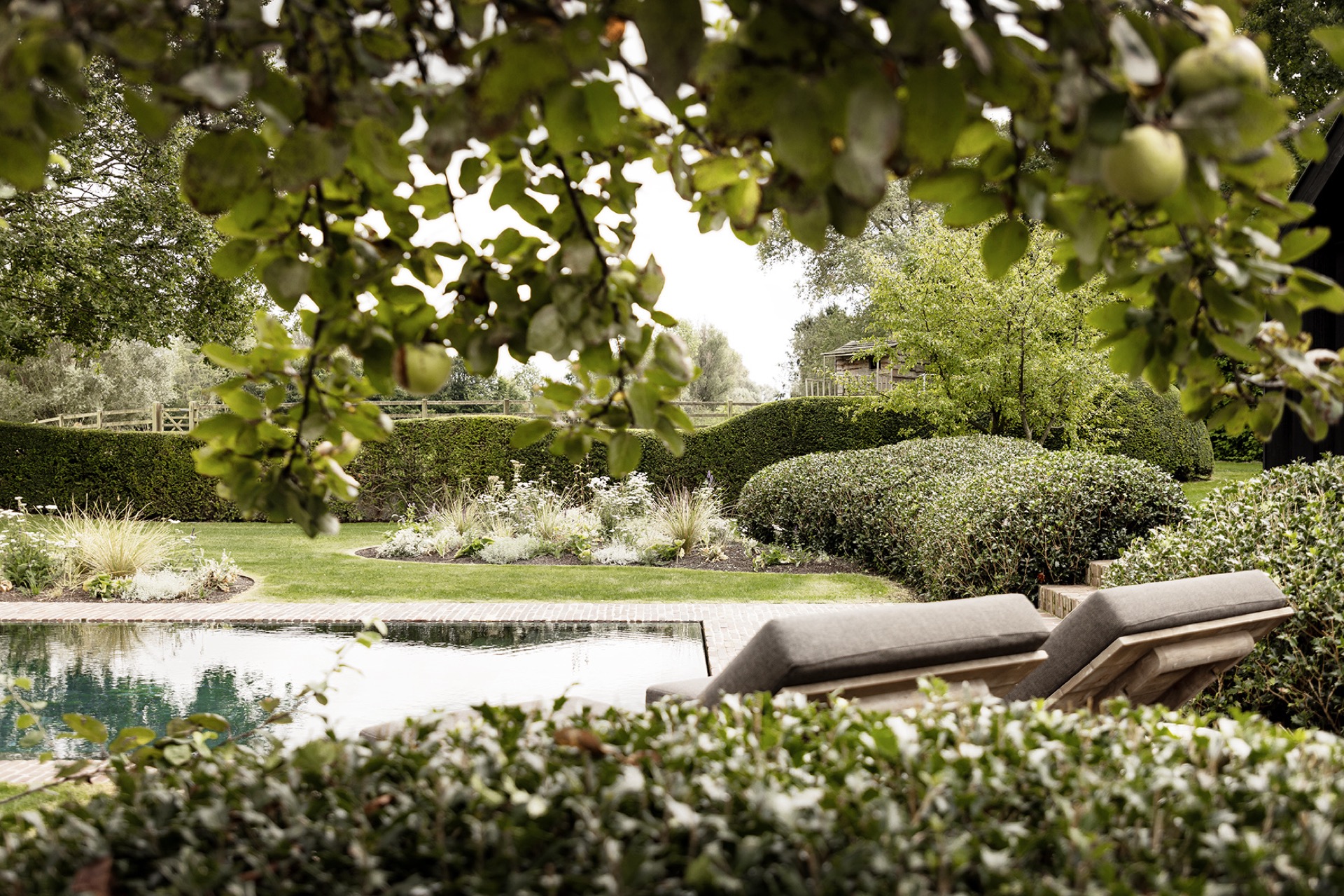 landscape garden sightline: lawn and cobblestone path along a brick facade with trimmed hedges, Luxury, Design, Exclusive, Modern, Custom Made, Special, Beautiful