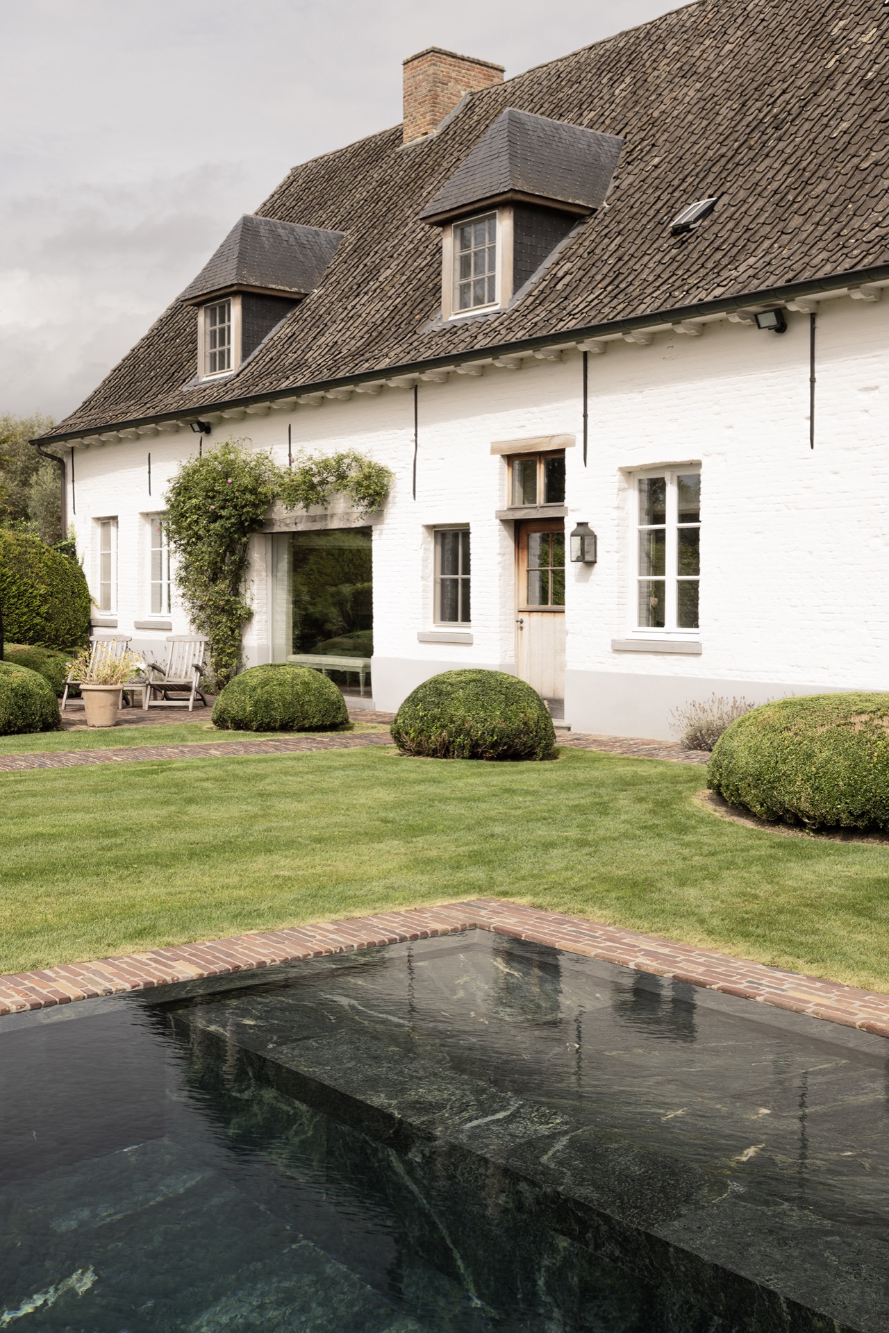 landscape garden sightline: side view of the farm facade with red roof tiles and trimmed hedges, Luxury, Design, Exclusive, Modern, Custom Made, Special, Beautiful