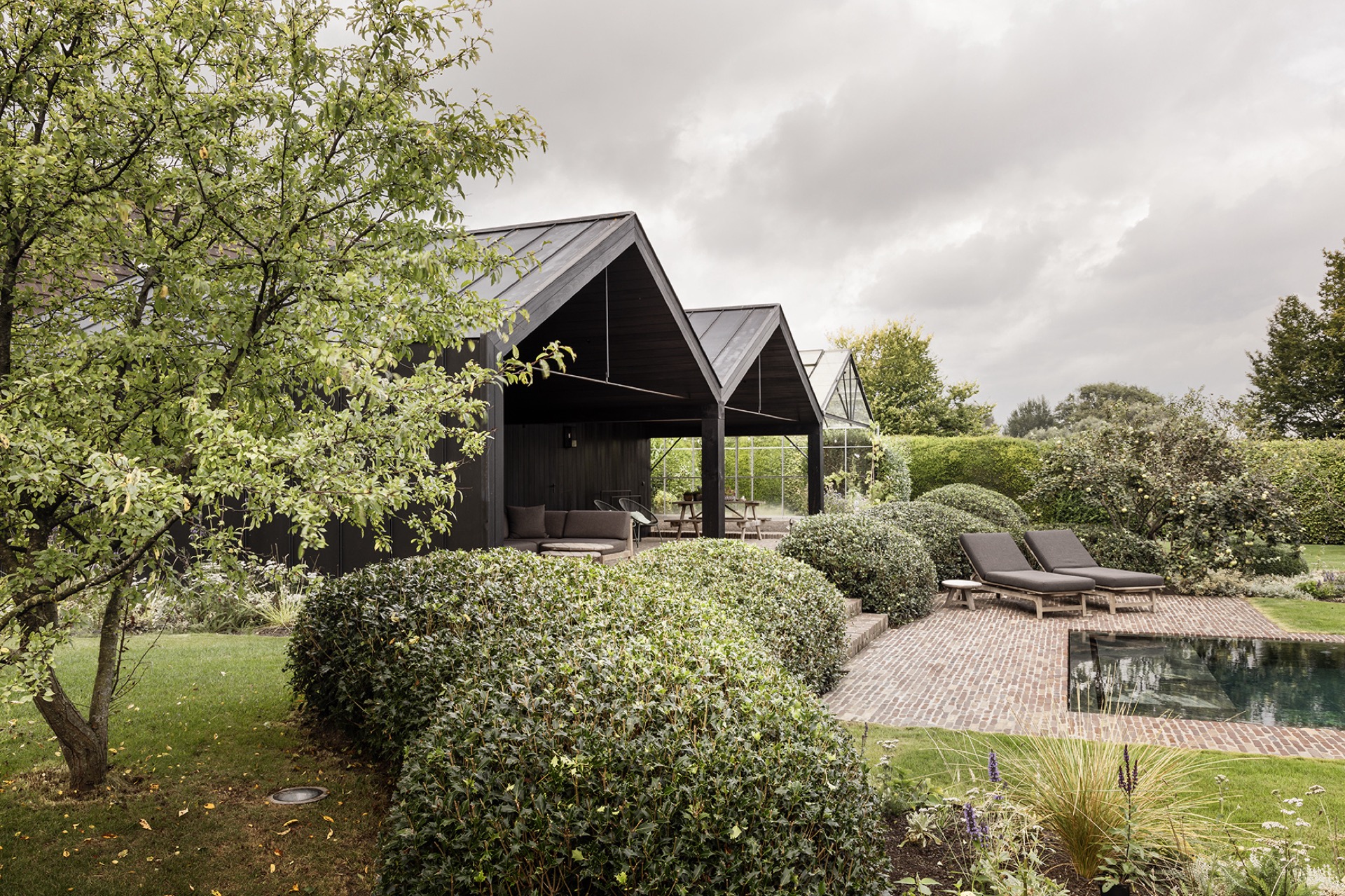 landscape garden sightline: long narrow pool with a natural-stone edge and dark wooden pavilion, Luxury, Design, Exclusive, Modern, Custom Made, Special, Beautiful
